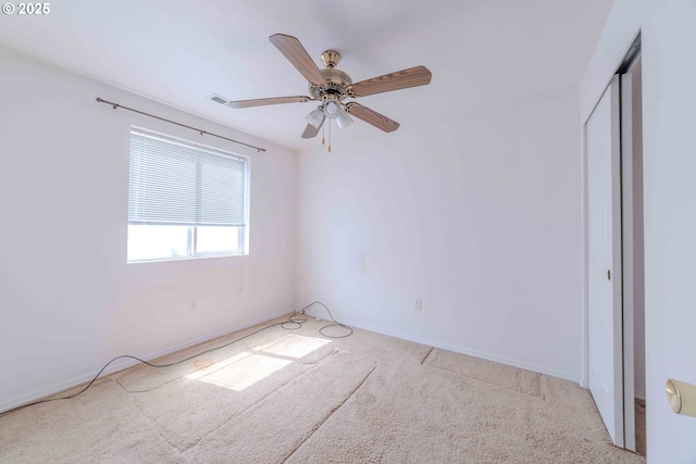 unfurnished bedroom featuring carpet floors, baseboards, a ceiling fan, and a closet
