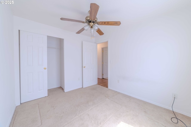 unfurnished bedroom featuring baseboards, ceiling fan, carpet, and a closet