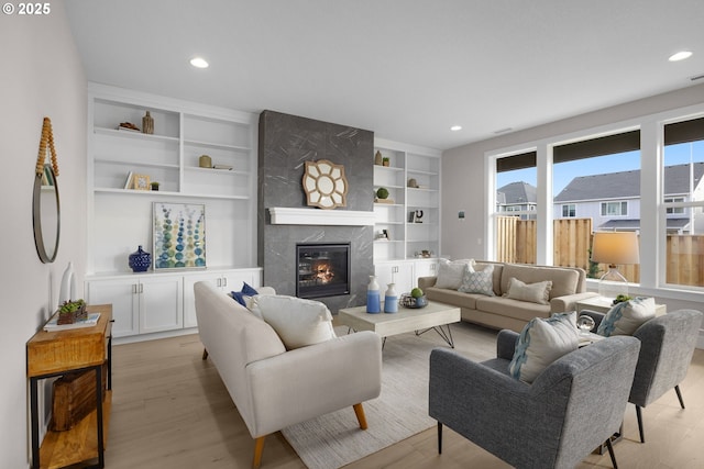 17716 NW Layla Dr Lot 28, Portland, OR 97229 - living room featuring light wood-type flooring, a premium fireplace, recessed lighting, and built in shelves