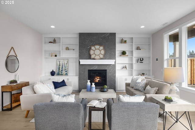 17716 NW Layla Dr Lot 28, Portland, OR 97229 - living room with healthy amount of natural light, light wood-type flooring, a high end fireplace, recessed lighting, and built in shelves