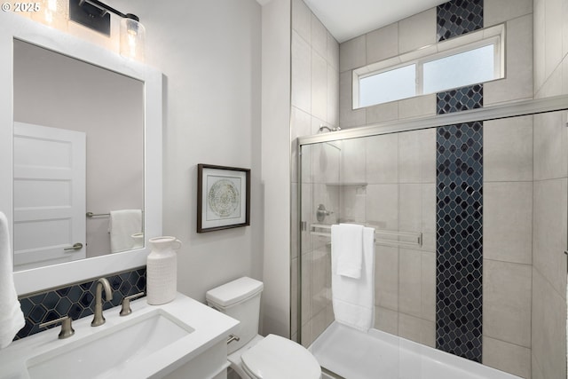 17716 NW Layla Dr Lot 28, Portland, OR 97229 - bathroom featuring toilet, a stall shower, vanity, and decorative backsplash