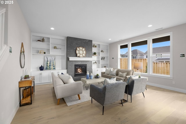 17716 NW Layla Dr Lot 28, Portland, OR 97229 - living room featuring light wood-style floors, a premium fireplace, baseboards, recessed lighting, and built in features