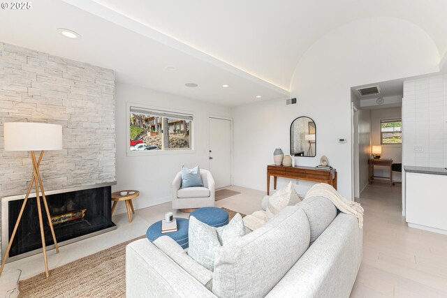 859 SW Broadway Dr Unit 41, Portland, OR 97201 - living room featuring lofted ceiling, recessed lighting, a stone fireplace, and visible vents