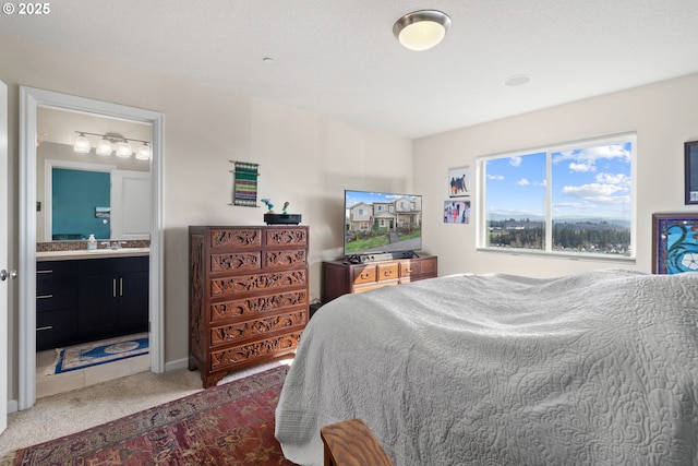 carpeted bedroom with ensuite bathroom