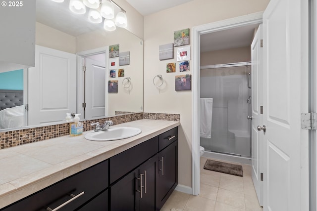 bathroom with toilet, decorative backsplash, vanity, a shower stall, and tile patterned floors