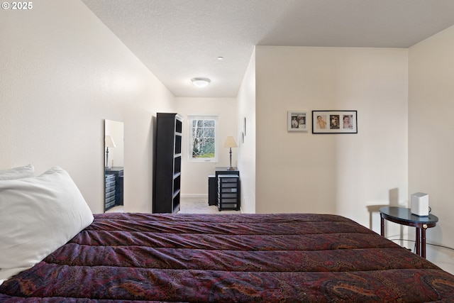 bedroom featuring carpet flooring and a textured ceiling