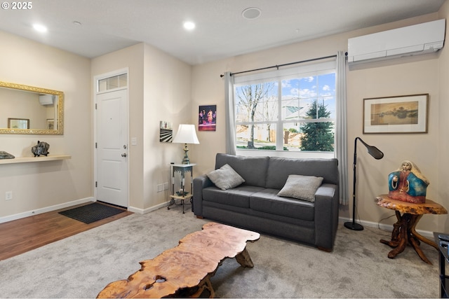 carpeted living area with baseboards, an AC wall unit, and recessed lighting