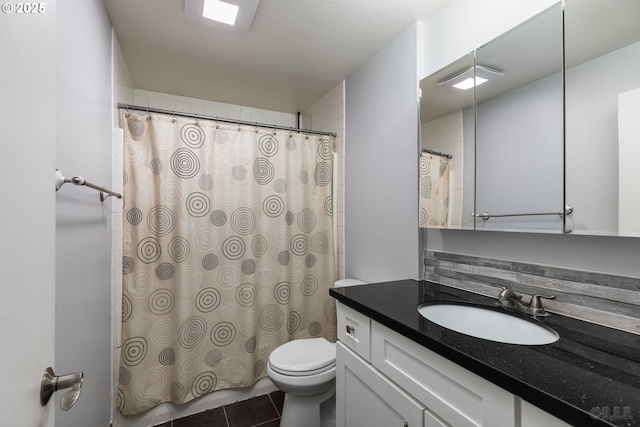 full bath with toilet, tile patterned floors, curtained shower, and vanity