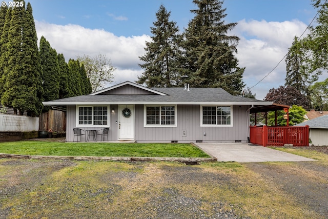 ranch-style home with a porch, crawl space, roof with shingles, fence, and a front lawn