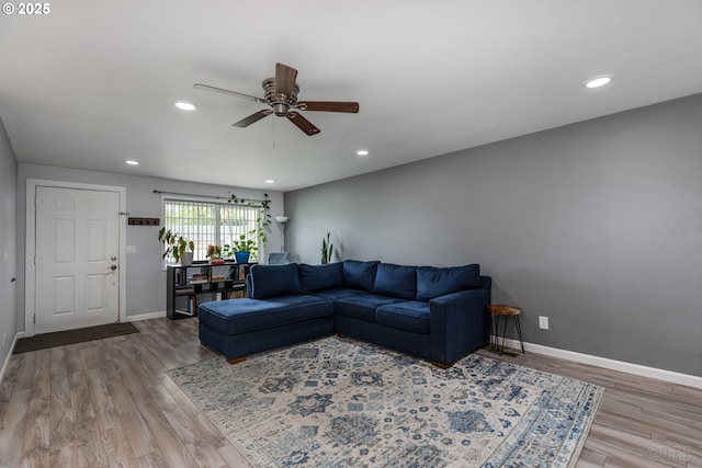 living area featuring a ceiling fan, baseboards, recessed lighting, and wood finished floors