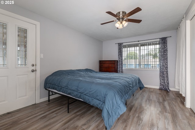 bedroom with baseboards, a ceiling fan, and wood finished floors