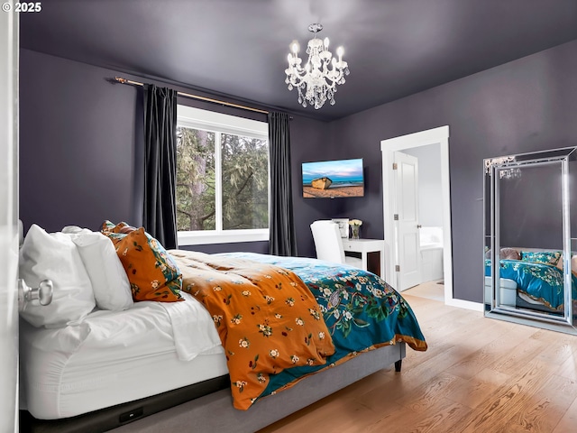 196 Dylan Ct, Gearhart, OR 97138 - bedroom featuring wood finished floors, a chandelier, connected bathroom, and baseboards