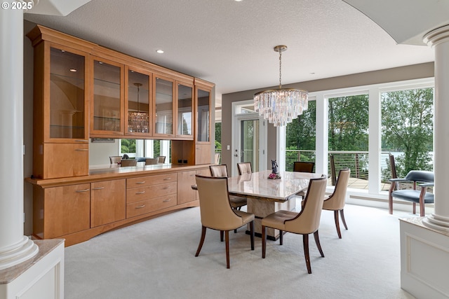 16215 SE Rivershore Dr, Vancouver, WA 98683 - dining space with light carpet, decorative columns, plenty of natural light, a textured ceiling, and recessed lighting