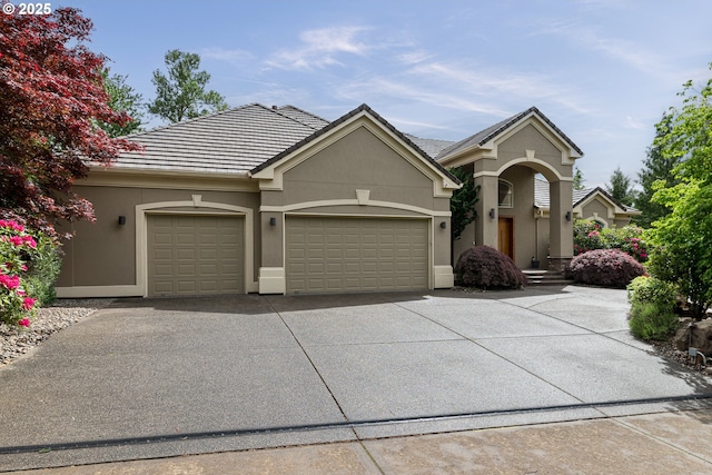 16215 SE Rivershore Dr, Vancouver, WA 98683 - view of front of home with an attached garage, concrete driveway, and stucco siding