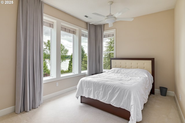 16215 SE Rivershore Dr, Vancouver, WA 98683 - carpeted bedroom featuring multiple windows, baseboards, and a ceiling fan