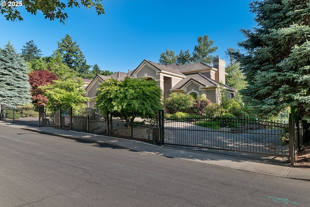 16215 SE Rivershore Dr, Vancouver, WA 98683 - view of property hidden behind natural elements with a chimney and a gate
