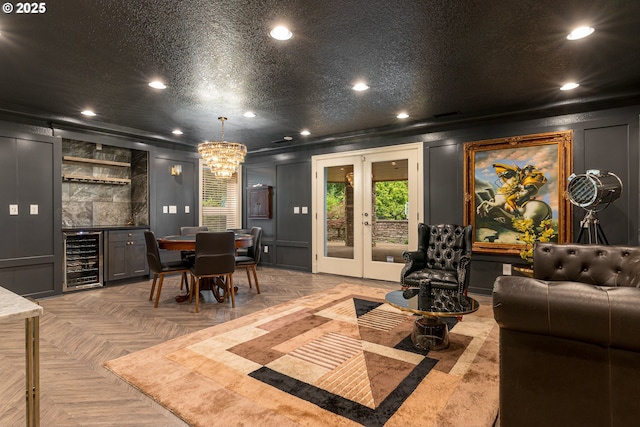 16215 SE Rivershore Dr, Vancouver, WA 98683 - dining space with beverage cooler, recessed lighting, a bar, a decorative wall, and french doors