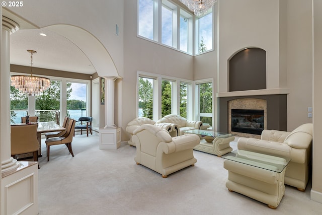 16215 SE Rivershore Dr, Vancouver, WA 98683 - living room featuring a chandelier, decorative columns, healthy amount of natural light, carpet floors, and a towering ceiling