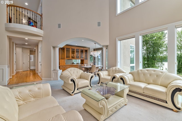 16215 SE Rivershore Dr, Vancouver, WA 98683 - living area with ornate columns, a high ceiling, arched walkways, a chandelier, and recessed lighting