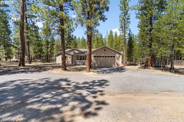 view of front of house featuring dirt driveway and a garage