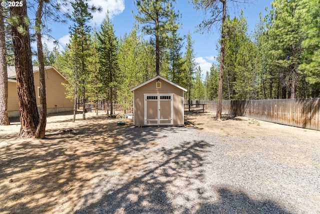 view of shed with fence