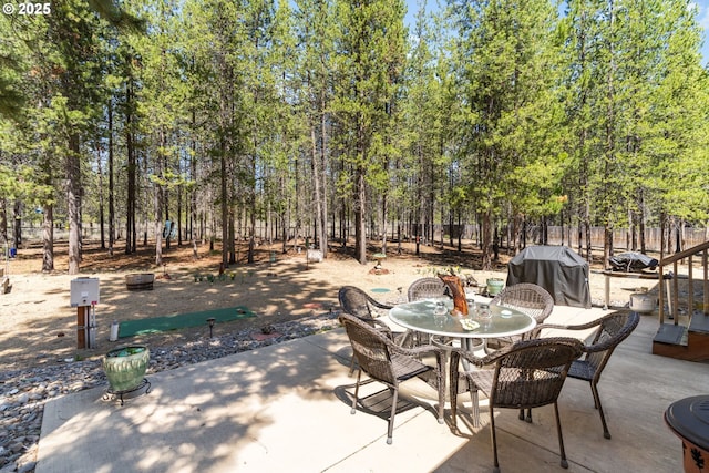 view of patio / terrace featuring a grill, fence, and outdoor dining space