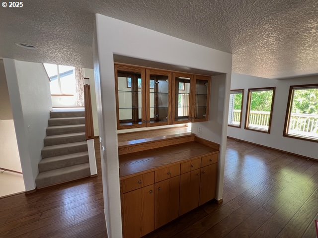 2217 NE 179th St Unit 22, Ridgefield, WA 98642 - interior space with tile countertops, a textured ceiling, and dark wood-type flooring