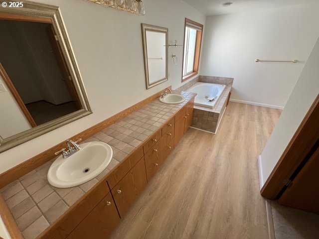 2217 NE 179th St Unit 22, Ridgefield, WA 98642 - full bath featuring double vanity, a sink, a garden tub, and wood finished floors