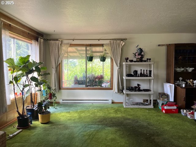 13727 SE Raymond St, Portland, OR 97236 - living area with carpet flooring, a textured ceiling, and a baseboard heating unit