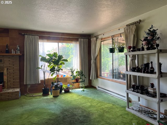 13727 SE Raymond St, Portland, OR 97236 - unfurnished room with a baseboard heating unit, a textured ceiling, and carpet