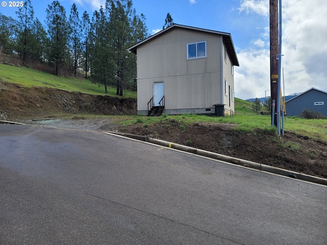 view of side of property with entry steps and crawl space