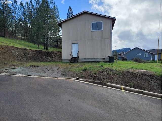 view of side of home featuring entry steps and crawl space