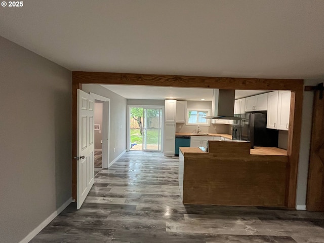 441 NE Johnson St, Myrtle Creek, OR 97457 - kitchen with dishwashing machine, a sink, refrigerator, white cabinets, and a peninsula