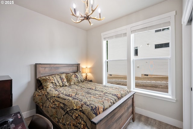 2188 SW Wallula Ln, Gresham, OR 97080 - bedroom with a chandelier, baseboards, and wood finished floors