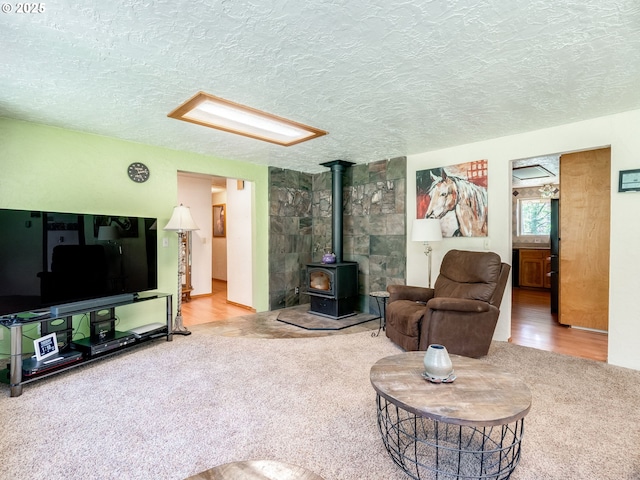 24873 S Beeson Rd, Beavercreek, OR 97004 - carpeted living area featuring a wood stove and a textured ceiling
