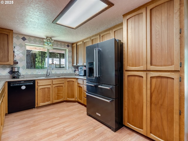 24873 S Beeson Rd, Beavercreek, OR 97004 - kitchen with black appliances, a textured ceiling, light wood-type flooring, and decorative backsplash