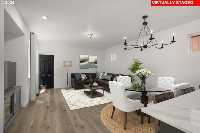 dining space with recessed lighting, baseboards, a chandelier, and light wood finished floors