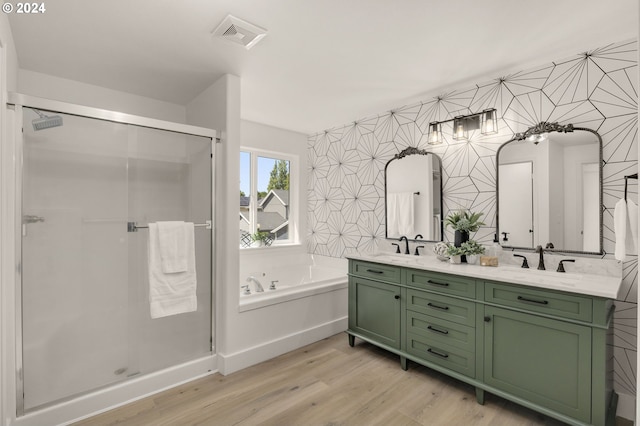 full bathroom with visible vents, wallpapered walls, a garden tub, a stall shower, and wood finished floors