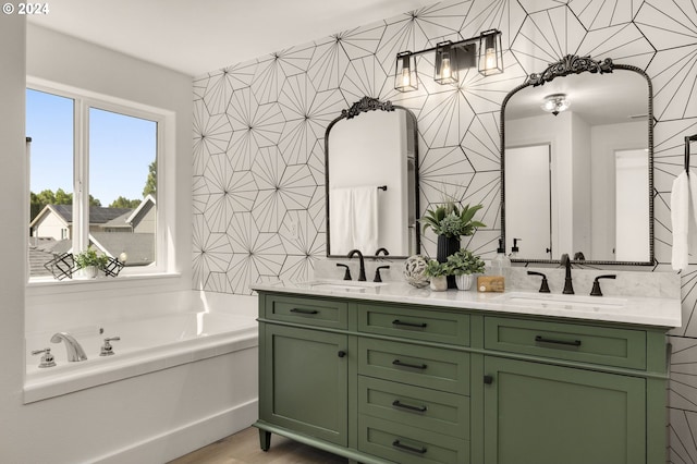 full bathroom featuring a bath, double vanity, wood finished floors, and a sink