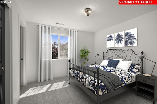 bedroom featuring visible vents, carpet flooring, and baseboards