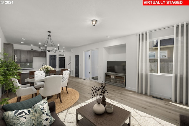 dining room featuring visible vents, light wood-style flooring, recessed lighting, an inviting chandelier, and baseboards