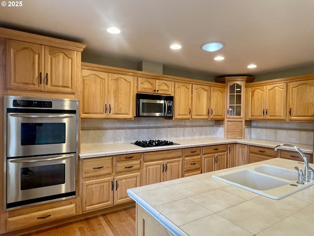 2180 Hayes St, North Bend, OR 97459 - kitchen with stainless steel appliances, a sink, tile countertops, recessed lighting, and backsplash