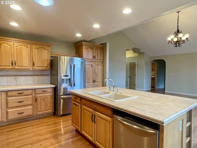 2180 Hayes St, North Bend, OR 97459 - kitchen with a sink, stainless steel appliances, arched walkways, tile countertops, and recessed lighting