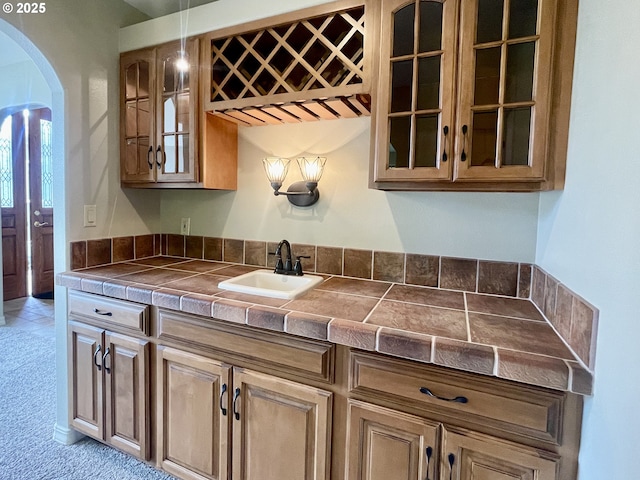 2180 Hayes St, North Bend, OR 97459 - kitchen with a sink, arched walkways, glass insert cabinets, and tile counters
