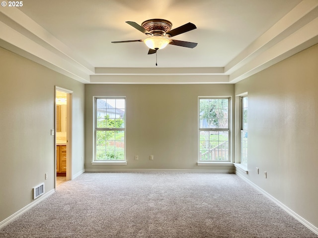 2180 Hayes St, North Bend, OR 97459 - carpeted empty room with ceiling fan, a tray ceiling, healthy amount of natural light, and baseboards