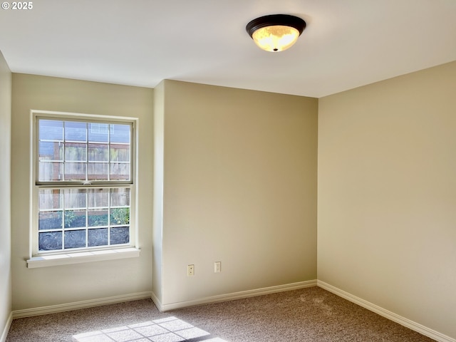 carpeted spare room with baseboards