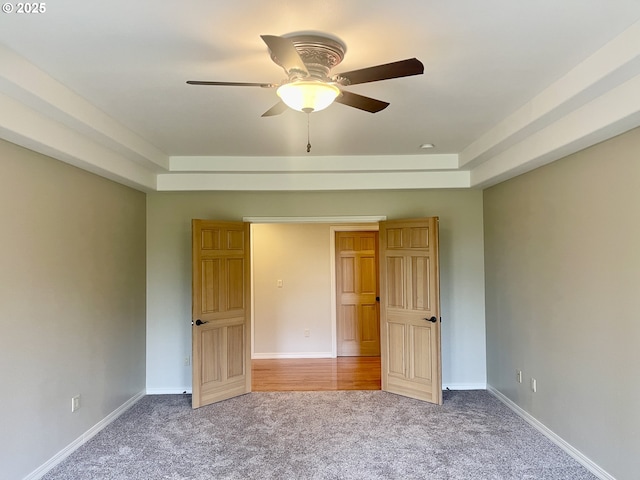 2180 Hayes St, North Bend, OR 97459 - unfurnished bedroom with carpet, baseboards, ceiling fan, and a raised ceiling