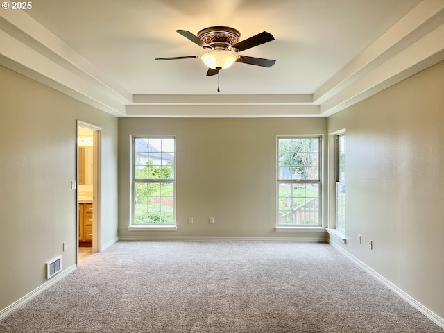 empty room featuring visible vents, baseboards, and carpet