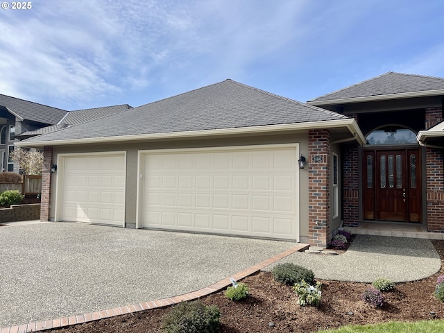 view of front of house with driveway, brick siding, an attached garage, and a shingled roof