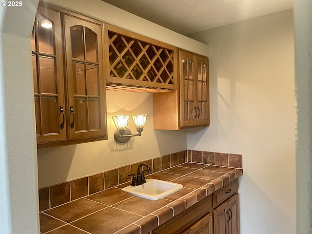 2180 Hayes St, North Bend, OR 97459 - kitchen featuring a sink, tile counters, and brown cabinets